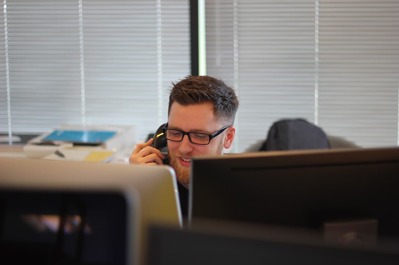 Support team using headsets at their desks